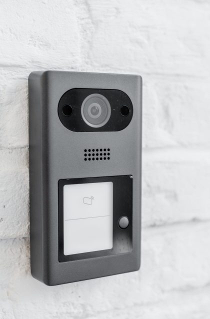 House intercom with a camera on the brick wall outdooors